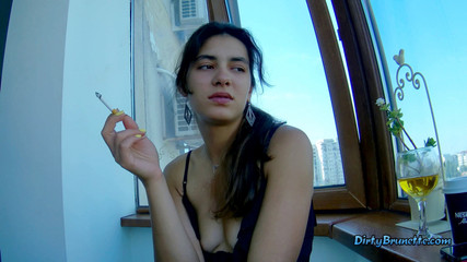 Fingering her pussy on the balcony while smoking