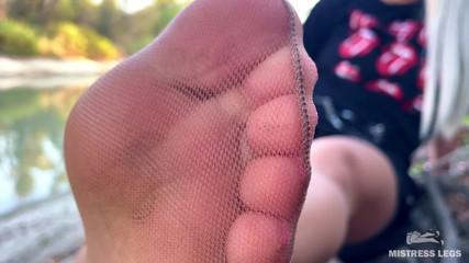 My Cute Feet in Nude Tights Rub Against Each Other on the Autumn River Bank