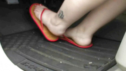 Pressing gas pedal in red sandals