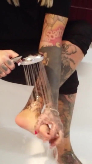 Tattooed blonde MILF washes her feet