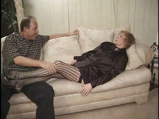 Mature is giving foot job on her living room