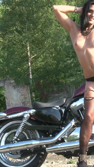 Fabulous brunette enjoys posing outdoors